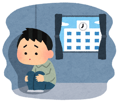 暗い部屋で膝をかかえる登校拒否の男の子